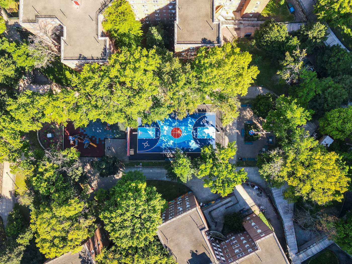 Patterson Houses basketball court after restoration, freshly painted in blue and red